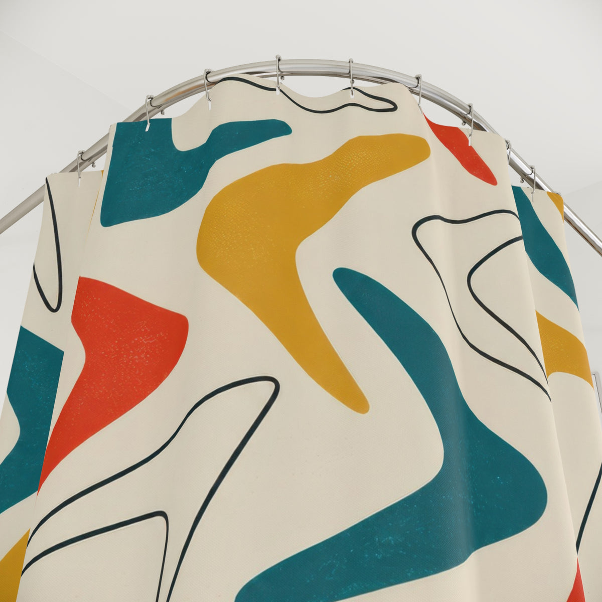 Teal, mustard and red boomerangs on ivory shower curtain with close-up print, hooks, and folds