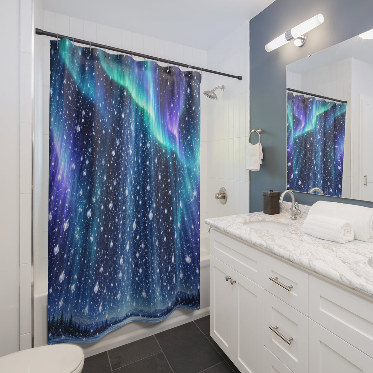 Aurora night snowfall shower curtain beside a white vanity
