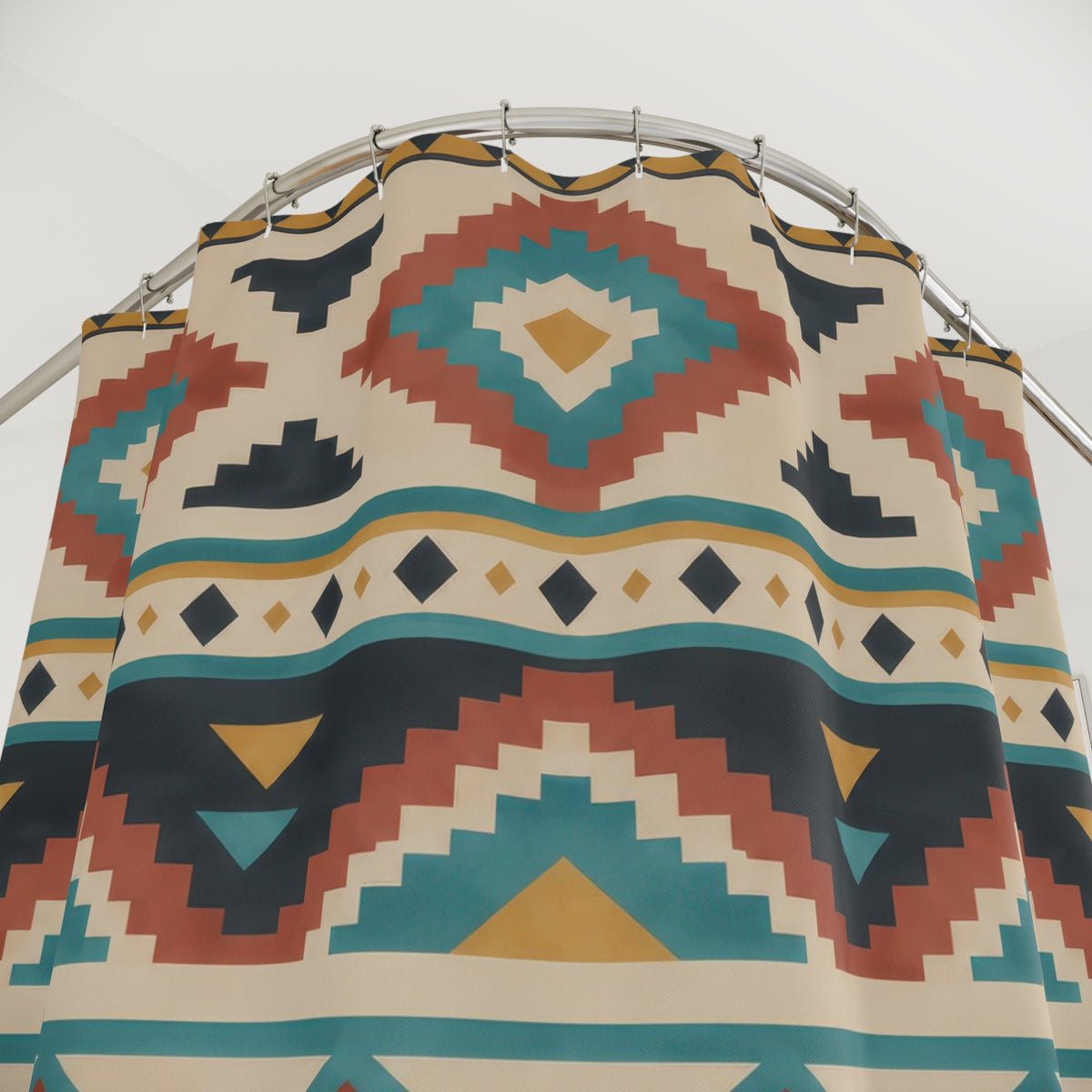 Terracotta and turquoise stepped diamonds on warm beige shower curtain with close-up print, hooks, and folds