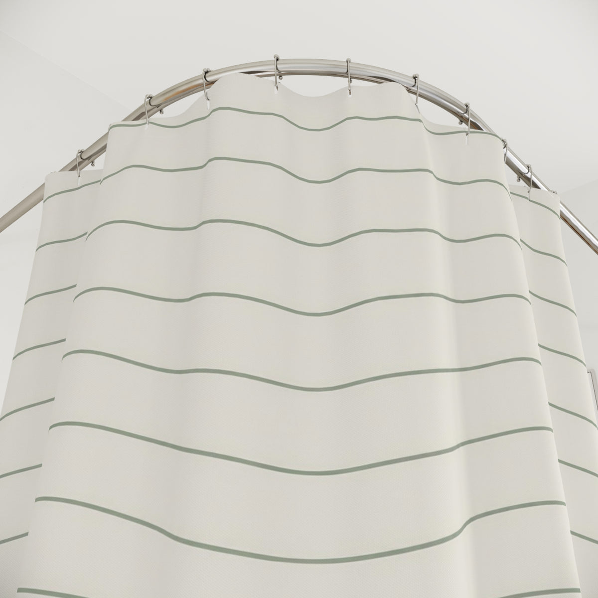 Thin sage green wave lines on warm ivory shower curtain with close-up print, hooks, and folds
