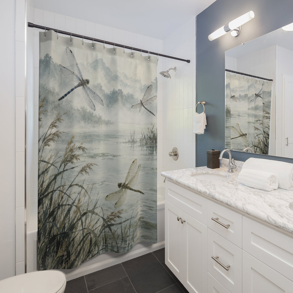 Blue-grey pond and hovering dragonflies shower curtain beside a white vanity