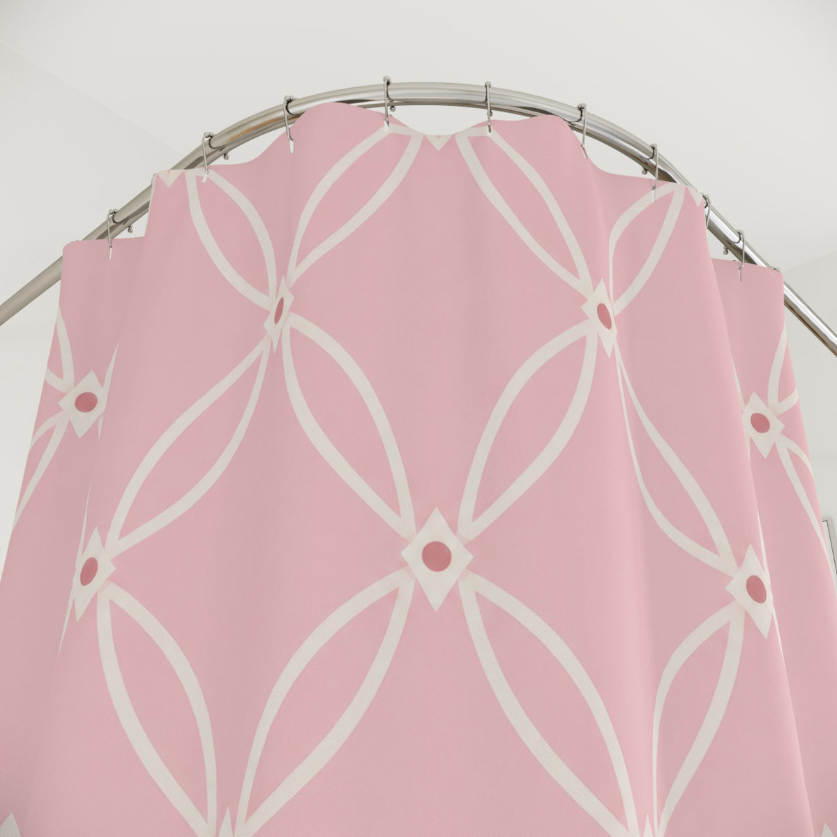 Ivory oval trellis on a light pink ground shower curtain with close-up print, hooks, and folds