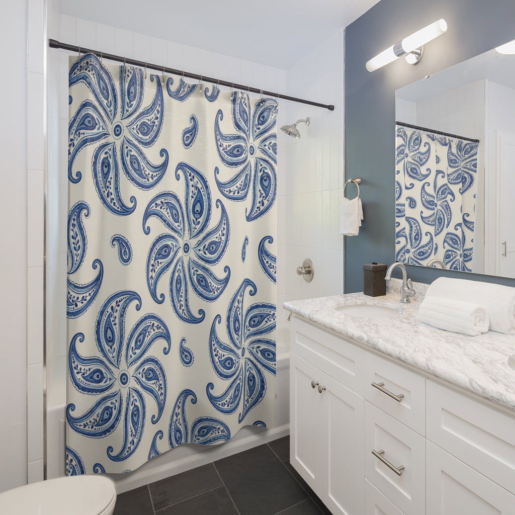 Cobalt blue paisley pinwheel medallions on ivory shower curtain beside a white vanity