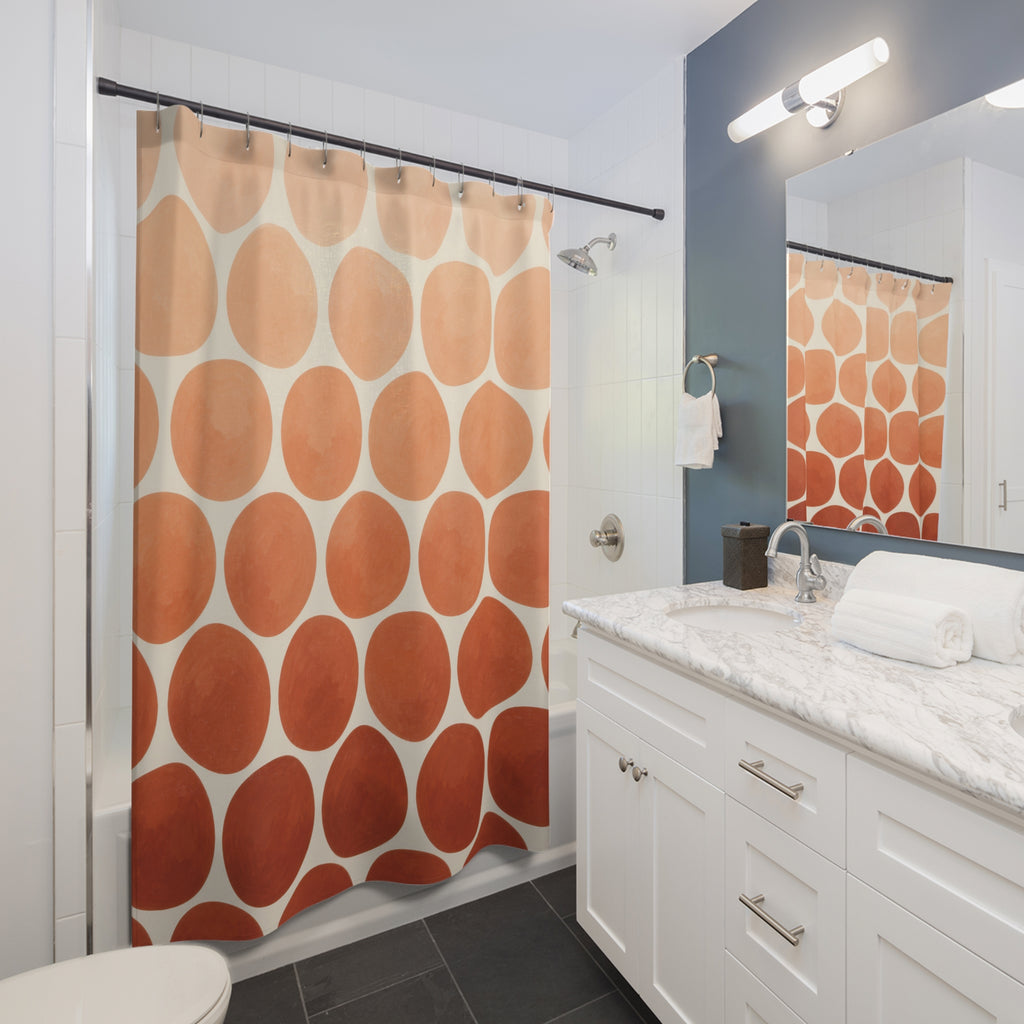 Peach to terracotta ombre dots on ivory shower curtain beside a white vanity