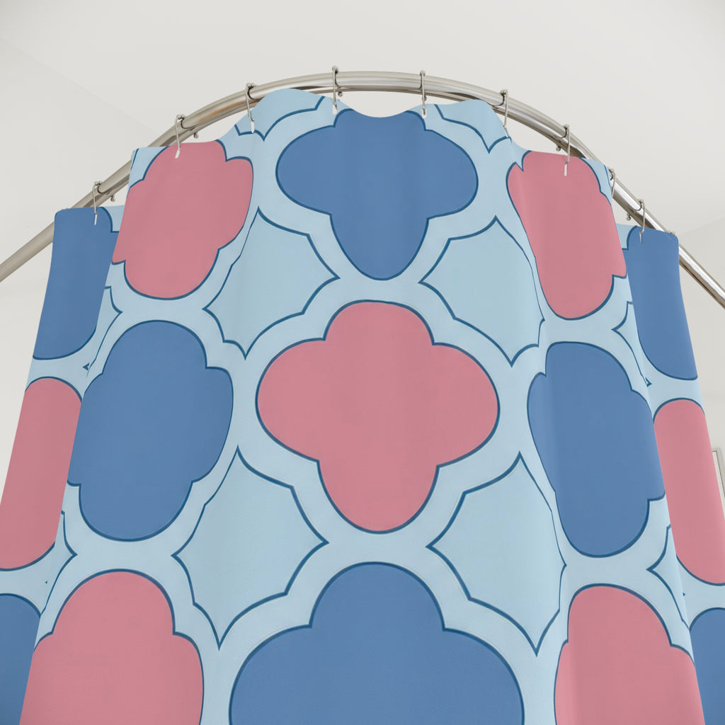 Blue and pink quatrefoils on a pale blue ground shower curtain with close-up print, hooks, and folds