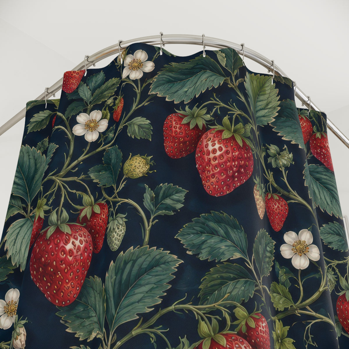 Red strawberry clusters with green leaves on navy shower curtain with close-up print, hooks, and folds