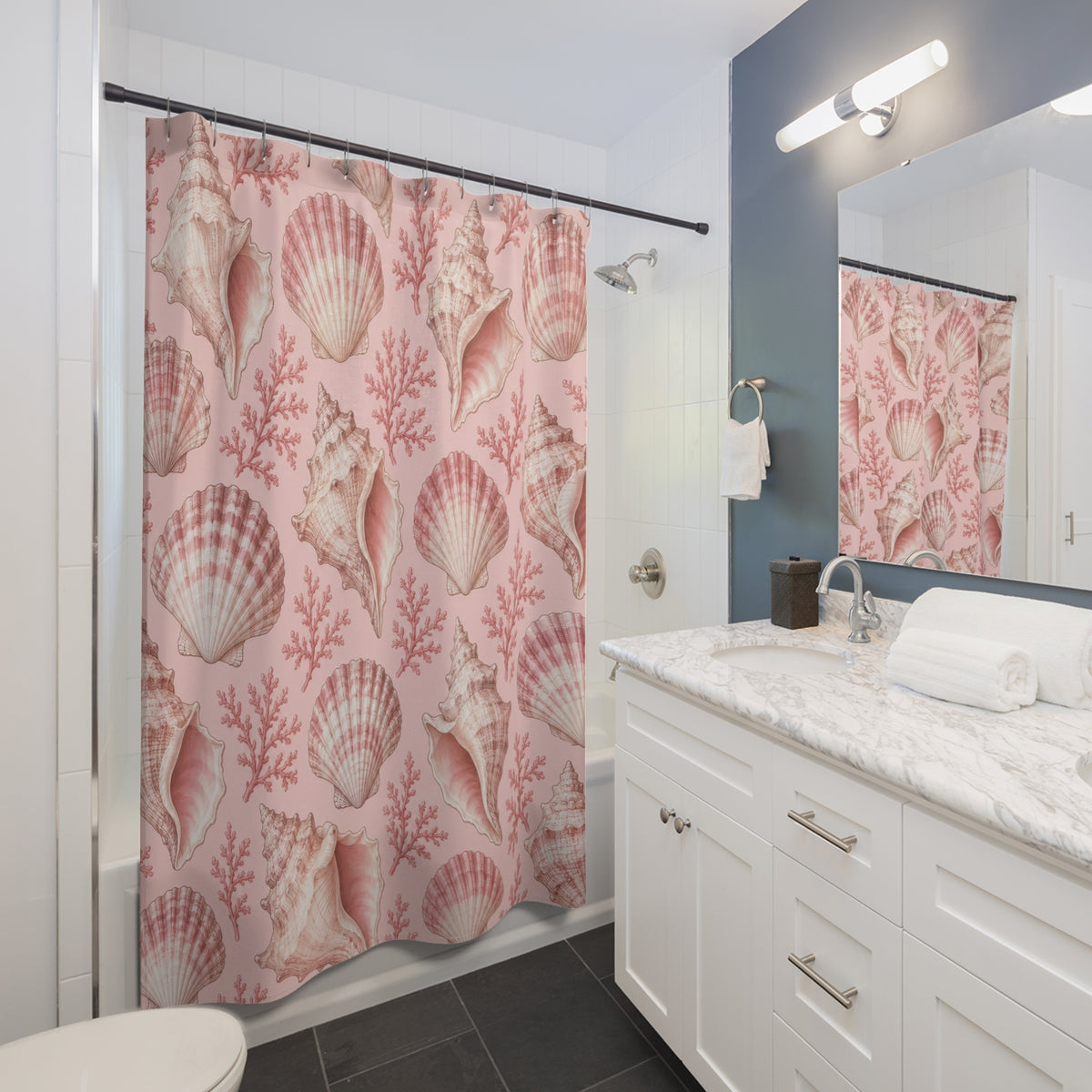 Light pink and ivory seashells with rose coral shower curtain beside a white vanity