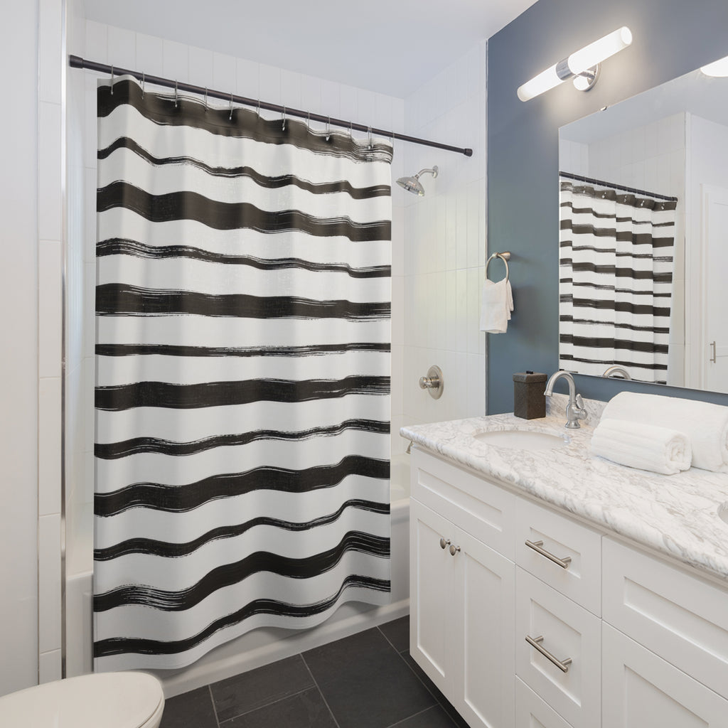 Horizontal black brush stripes with dry ink edges on white shower curtain beside a white vanity