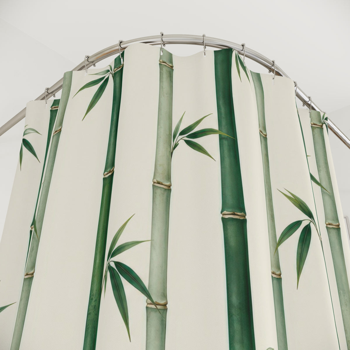 Green bamboo canes and small leaf fans on ivory shower curtain with close-up print, hooks, and folds
