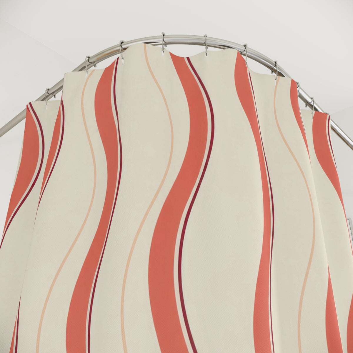 Coral wavy stripes with burgundy lines on cream shower curtain with close-up print, hooks, and folds