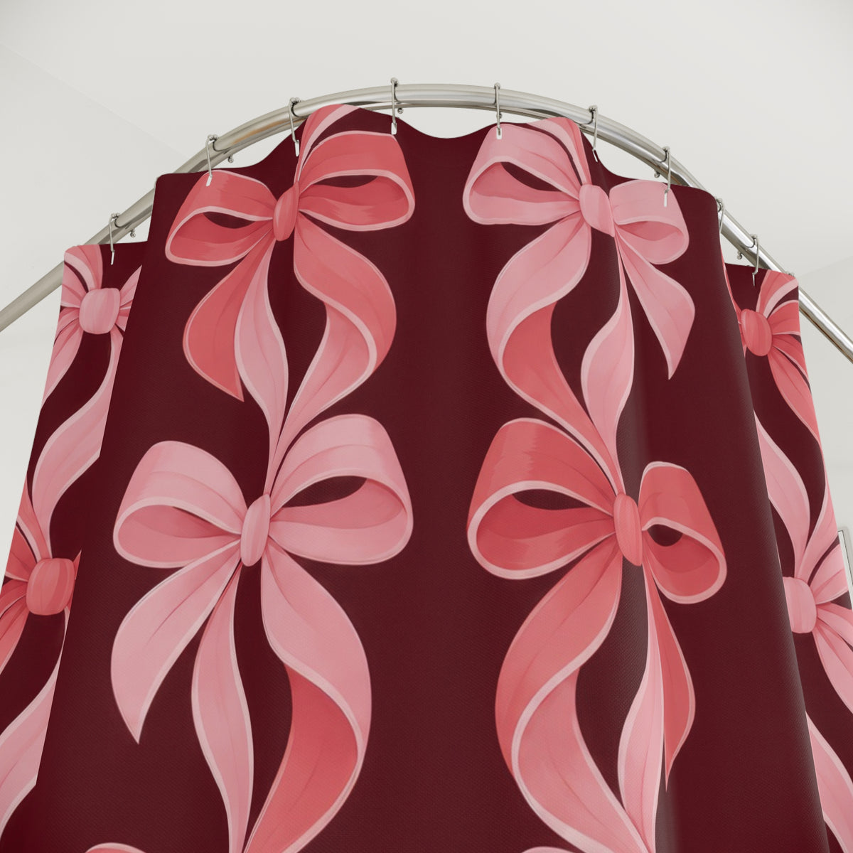 Pink bow chains in blush and coral on burgundy shower curtain with close-up print, hooks, and folds