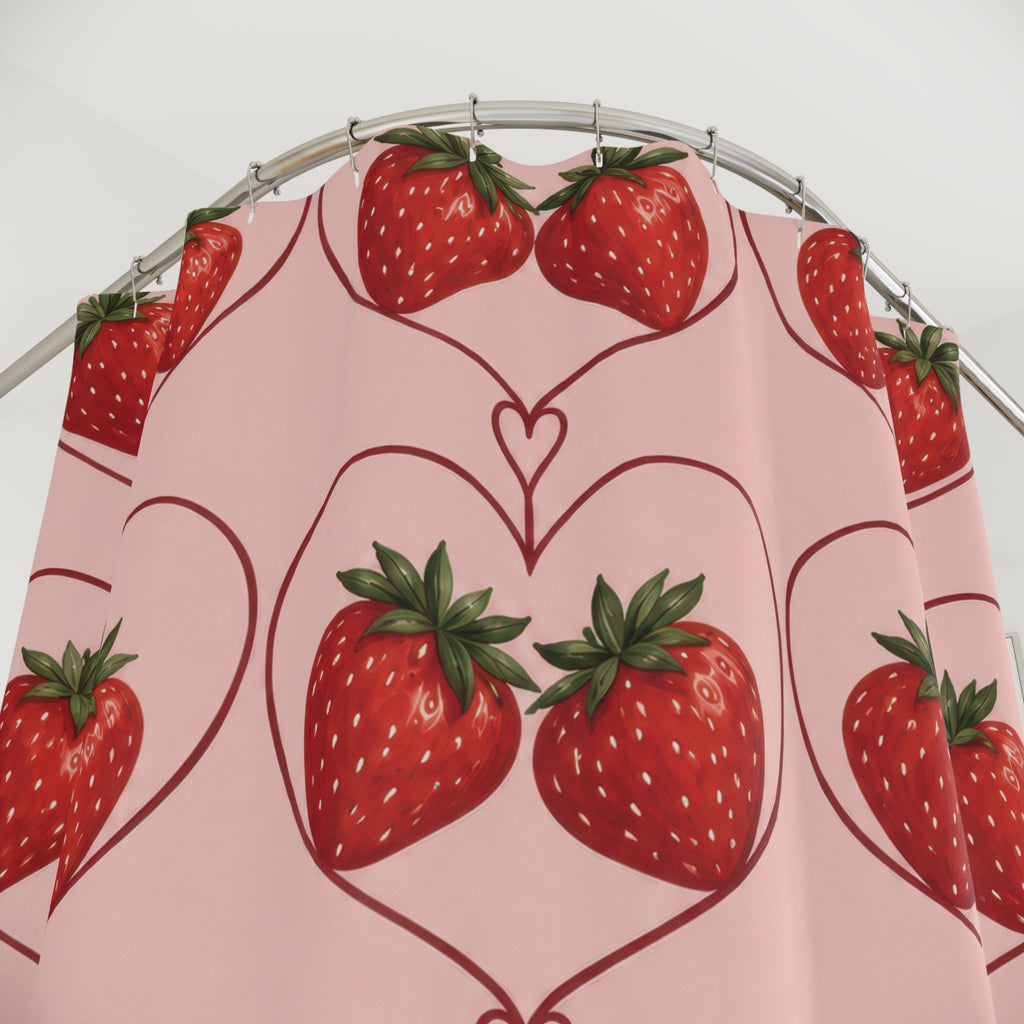 Red strawberry pairs in burgundy hearts on blush pink shower curtain with close-up print, hooks, and folds