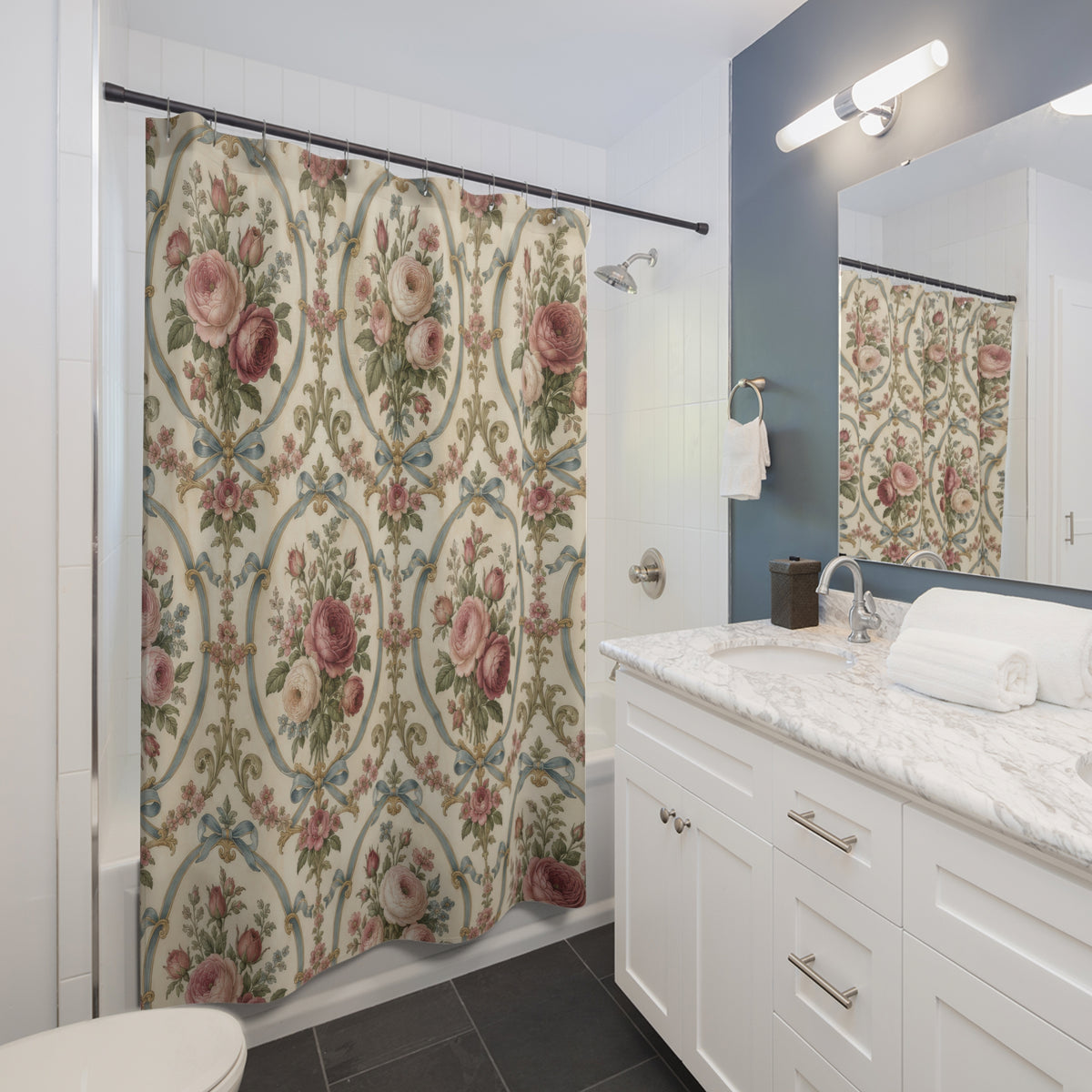 Pink roses in blue ribbon cartouches on warm cream shower curtain beside a white vanity