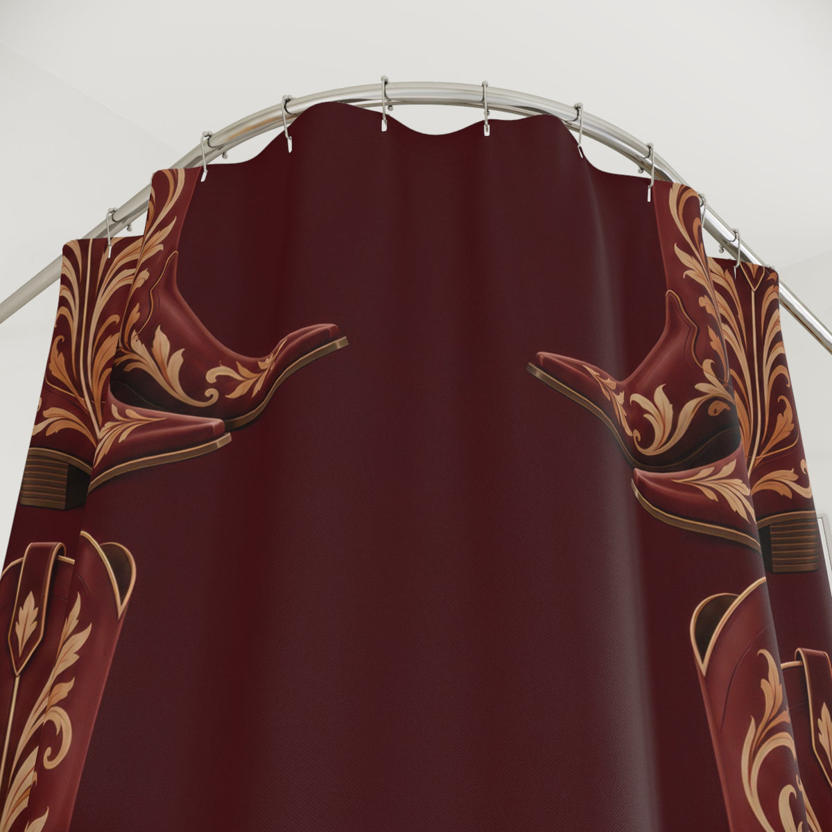 Maroon cowboy boots with cream and ochre scrollwork shower curtain with close-up print, hooks, and folds