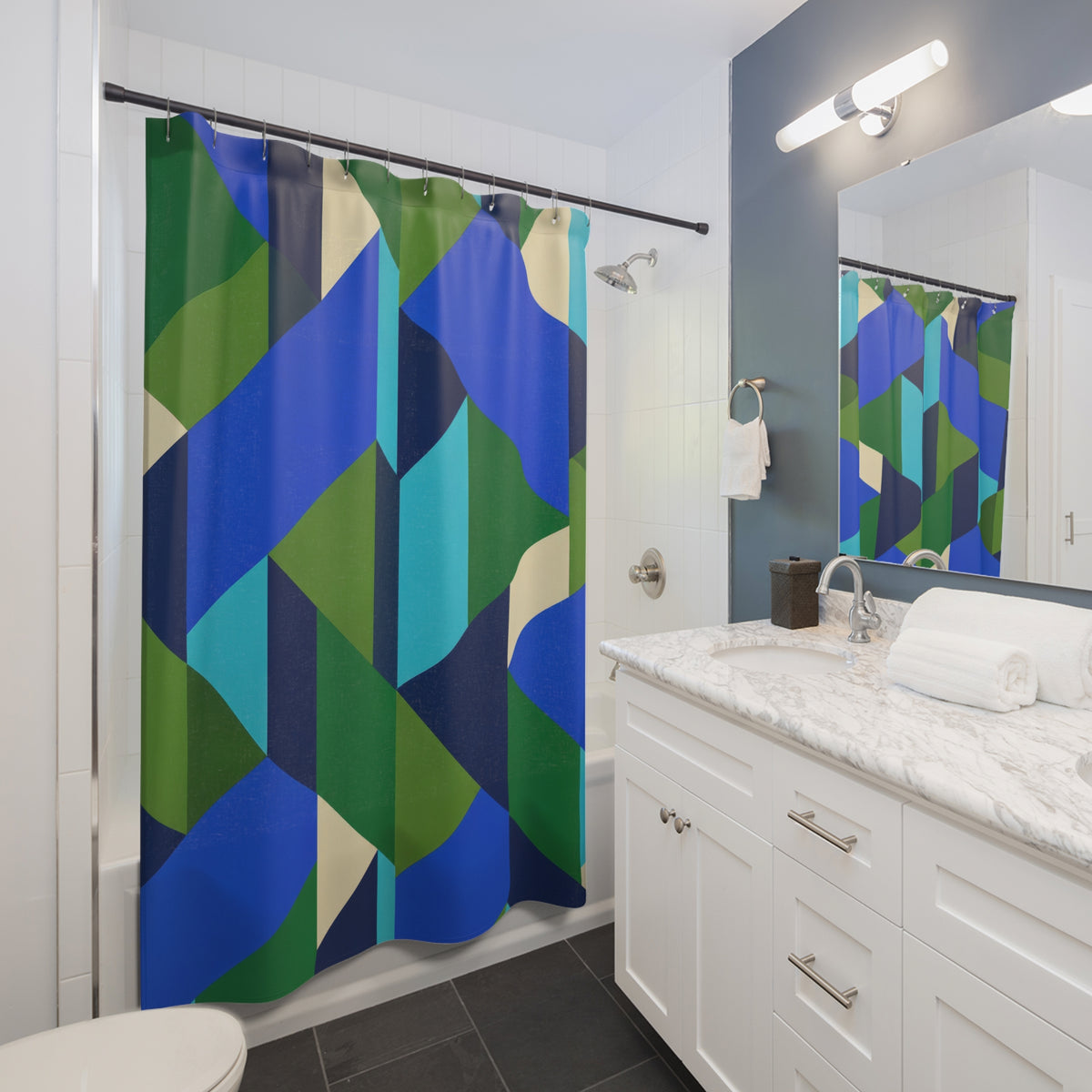 Interlocking blue, aqua and green facets with cream accents shower curtain beside a white vanity