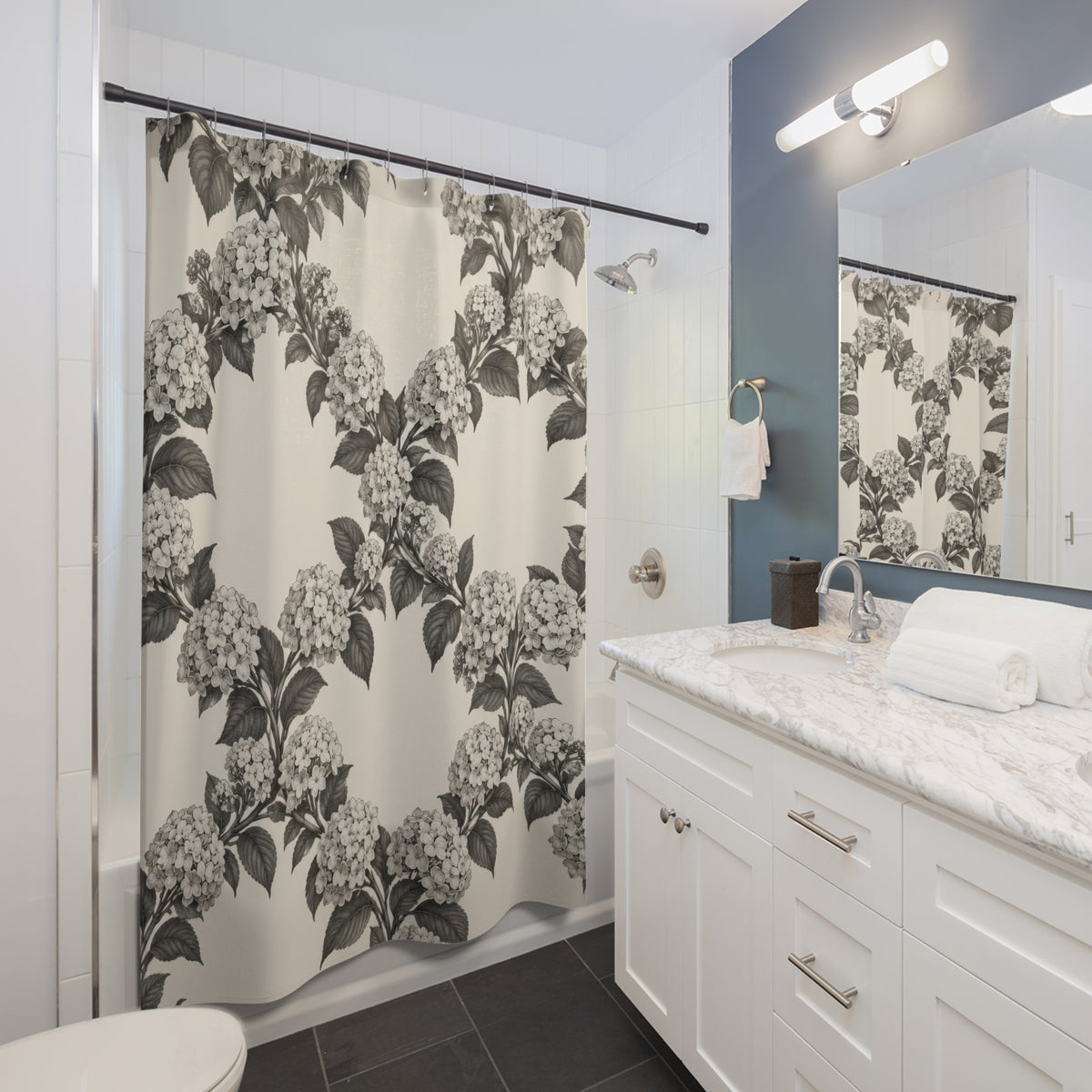 Charcoal hydrangea wreaths and leaves on warm cream shower curtain beside a white vanity