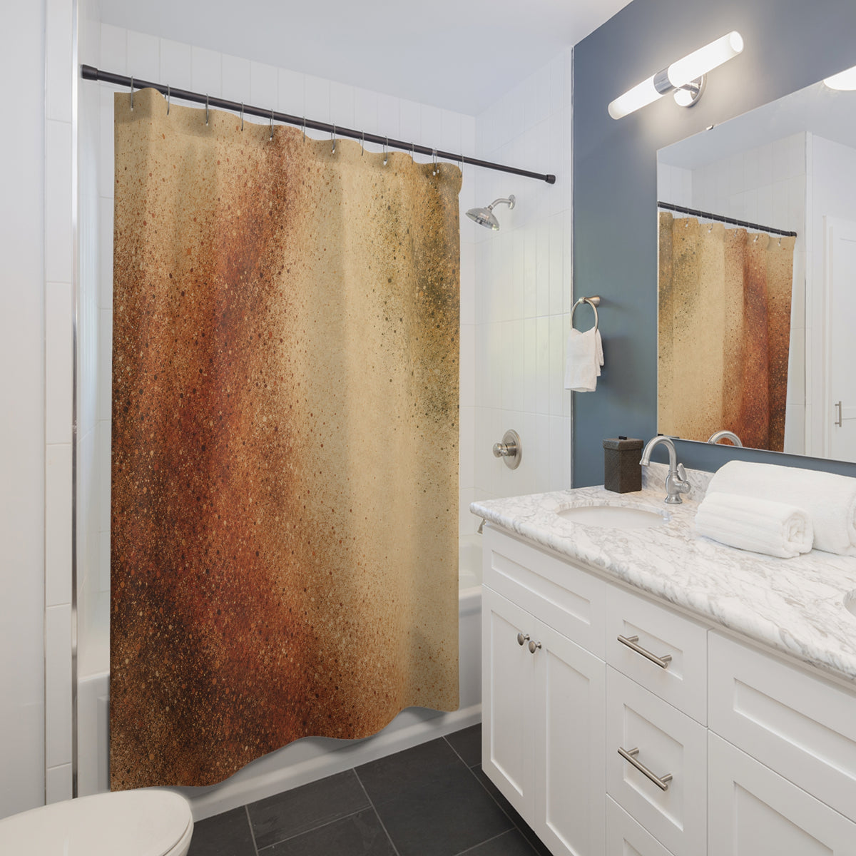 Rust and olive stippled clouds on warm sand shower curtain beside a white vanity
