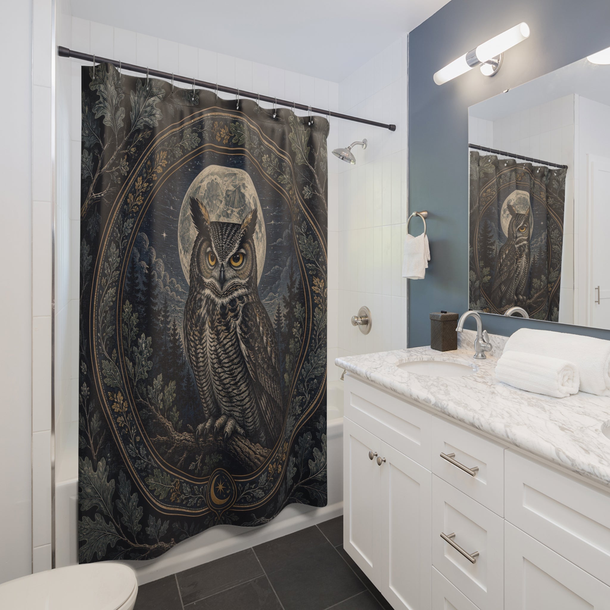 Indigo owl framed by a silver moonlit botanical medallion shower curtain installed beside a white vanity