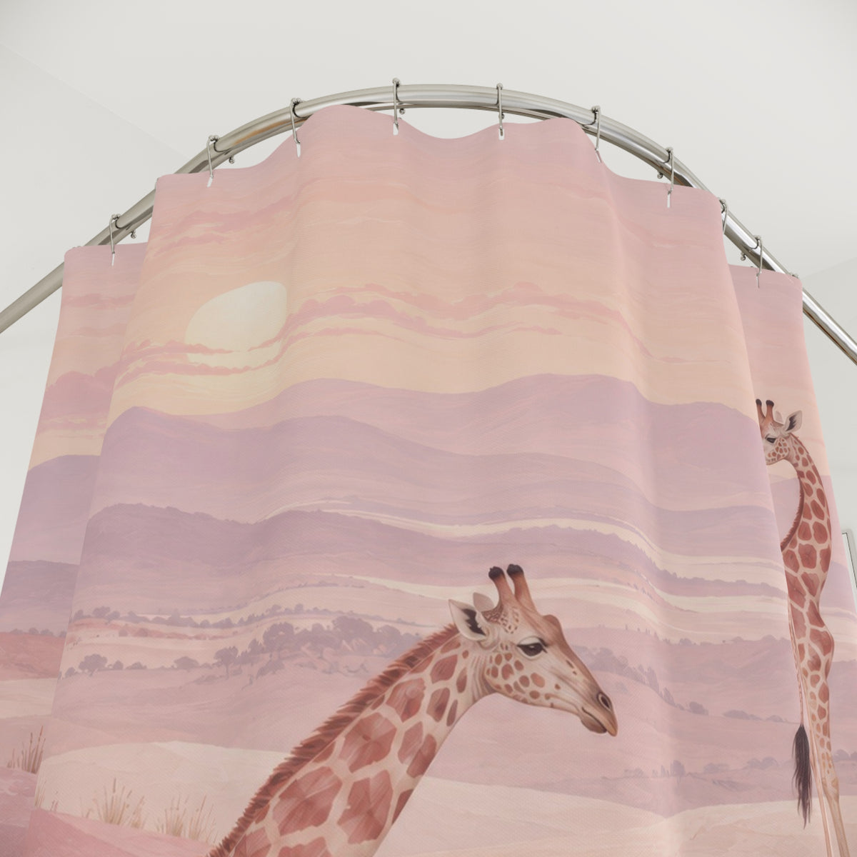 Two tan giraffes in a light pink hilly landscape shower curtain with close-up print, hooks, and folds
