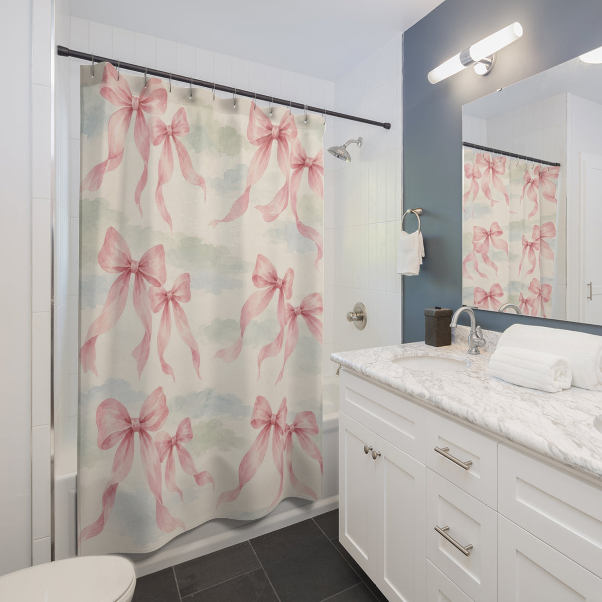 Pink bow pairs over pale sage and dusty blue washes shower curtain beside a white vanity