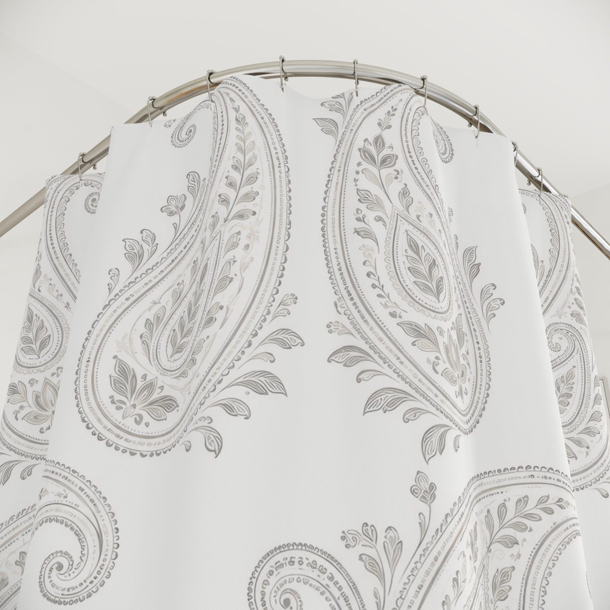 Pale gray leafy paisleys on a bright white ground shower curtain with close-up print, hooks, and folds