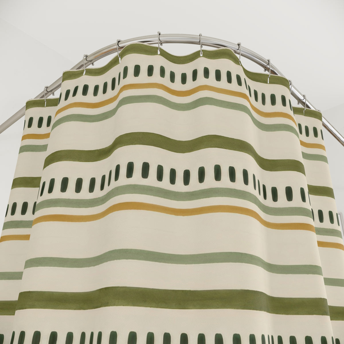 Olive and sage lines with forest-green dash rows on cream shower curtain with close-up print, hooks, and folds