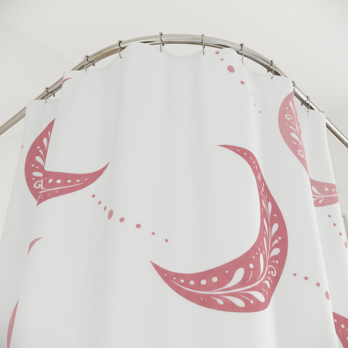 Pink crescent moons with white sprigs and dotted trails shower curtain with close-up print, hooks, and folds