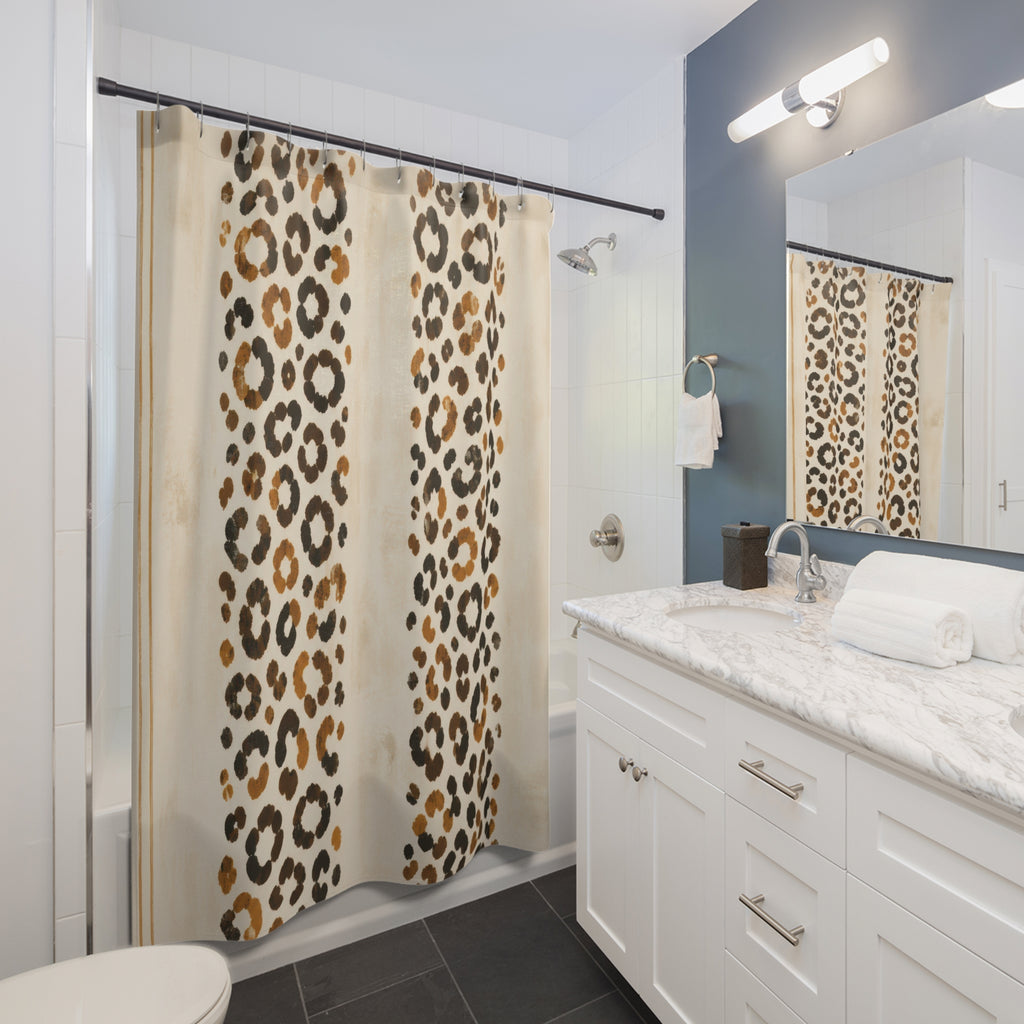 Twin bands of ochre cheetah print on cream shower curtain beside a white vanity