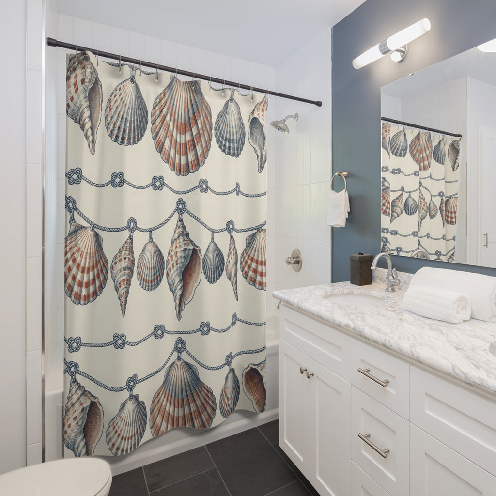 Navy and rust shell garlands with navy knots on ivory shower curtain beside a white vanity