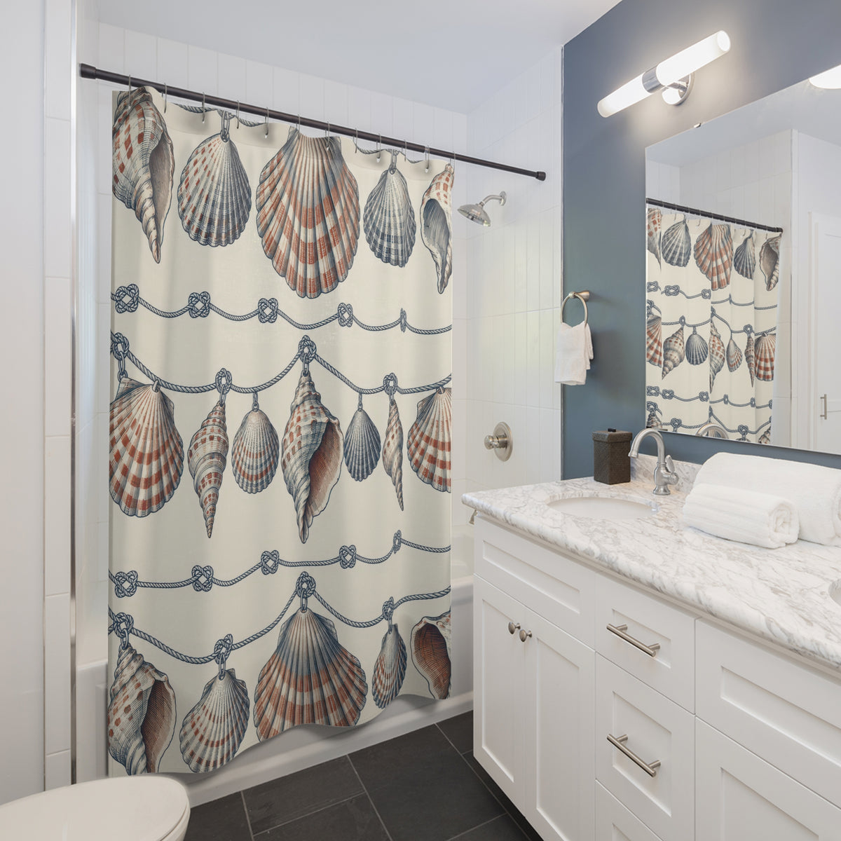 Navy and rust shell garlands with navy knots on ivory shower curtain beside a white vanity