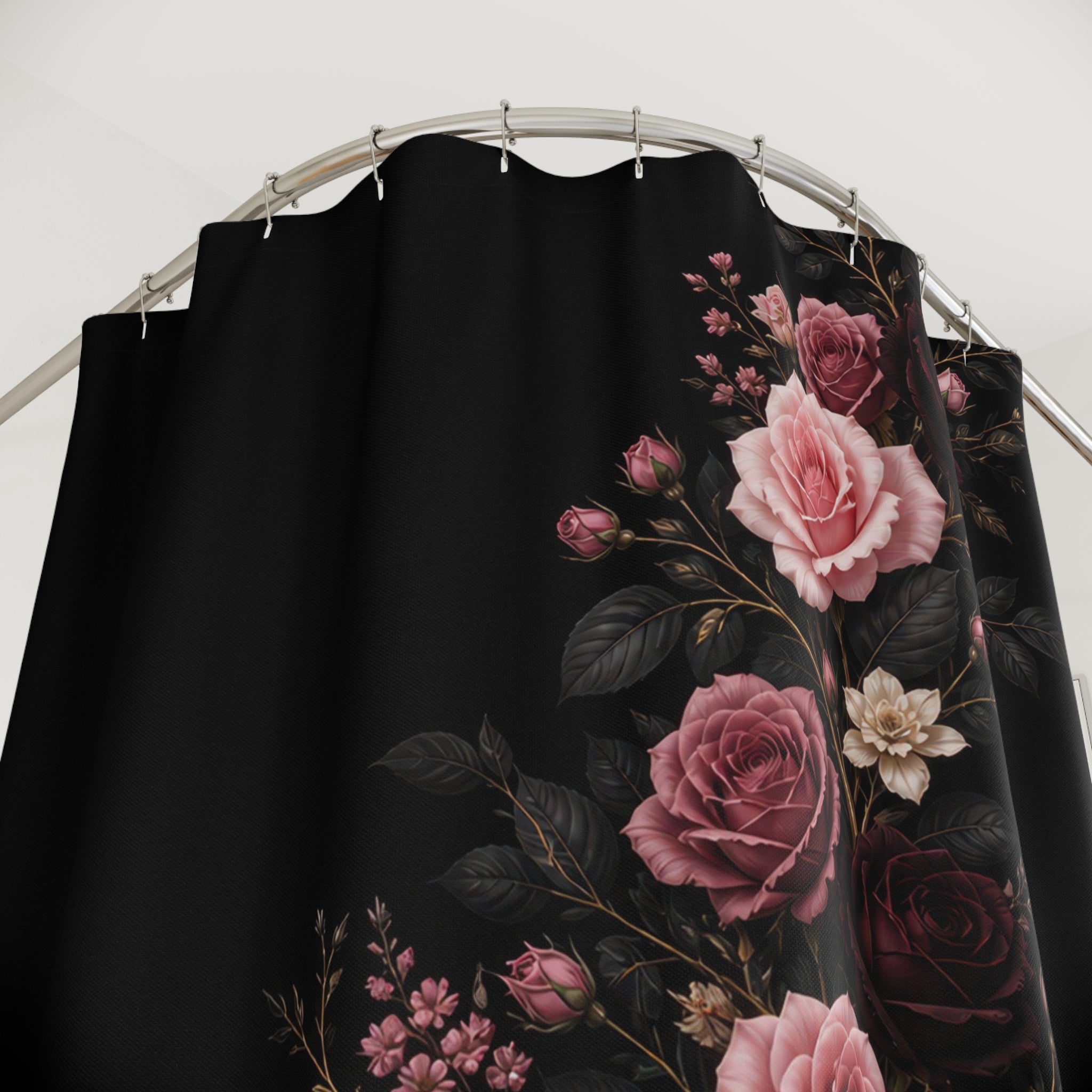 Close-up of Pink and burgundy roses rising in a serpentine curve on black shower curtain with hooks and folds