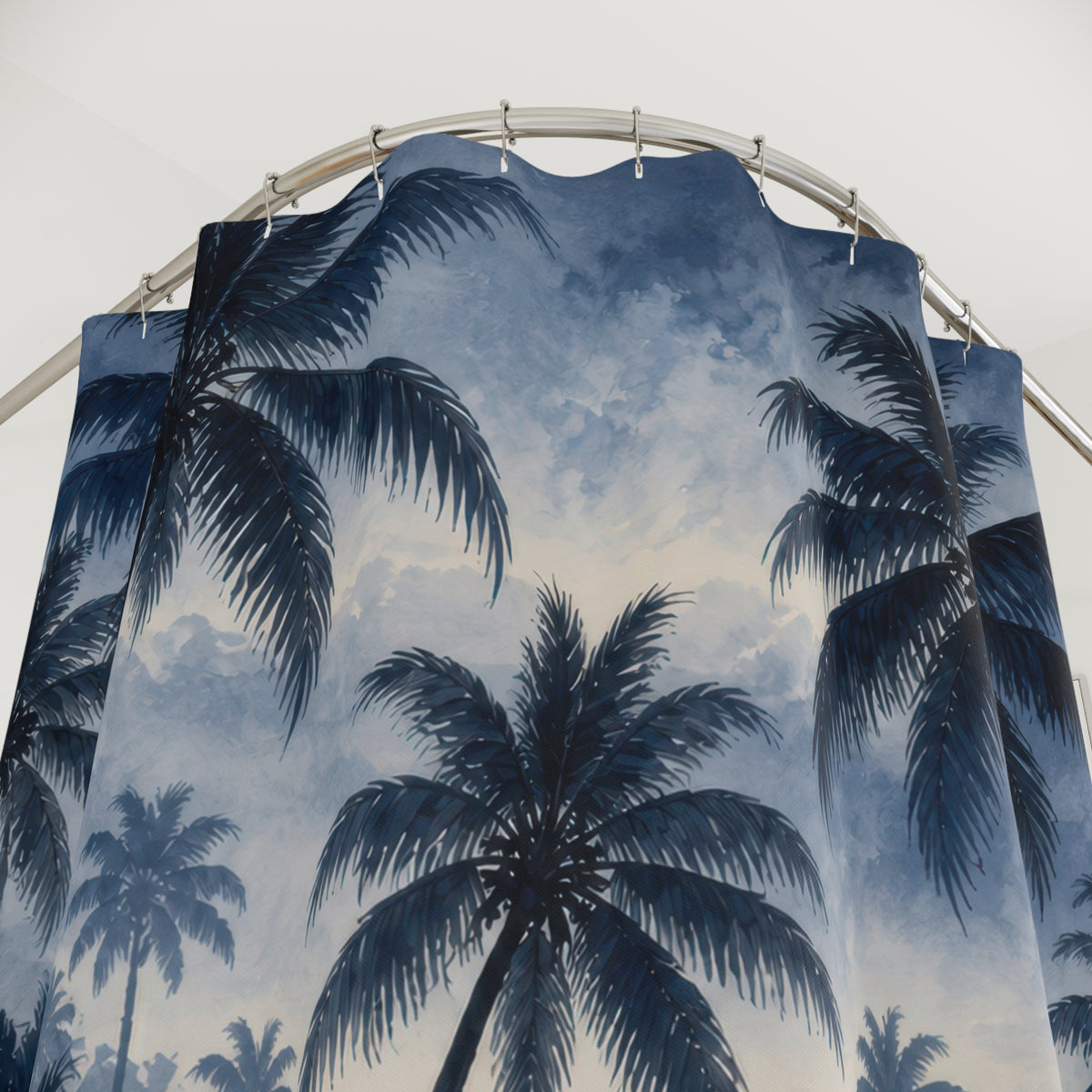 Navy palm grove fading into silvery blue mist shower curtain with close-up print, hooks, and folds
