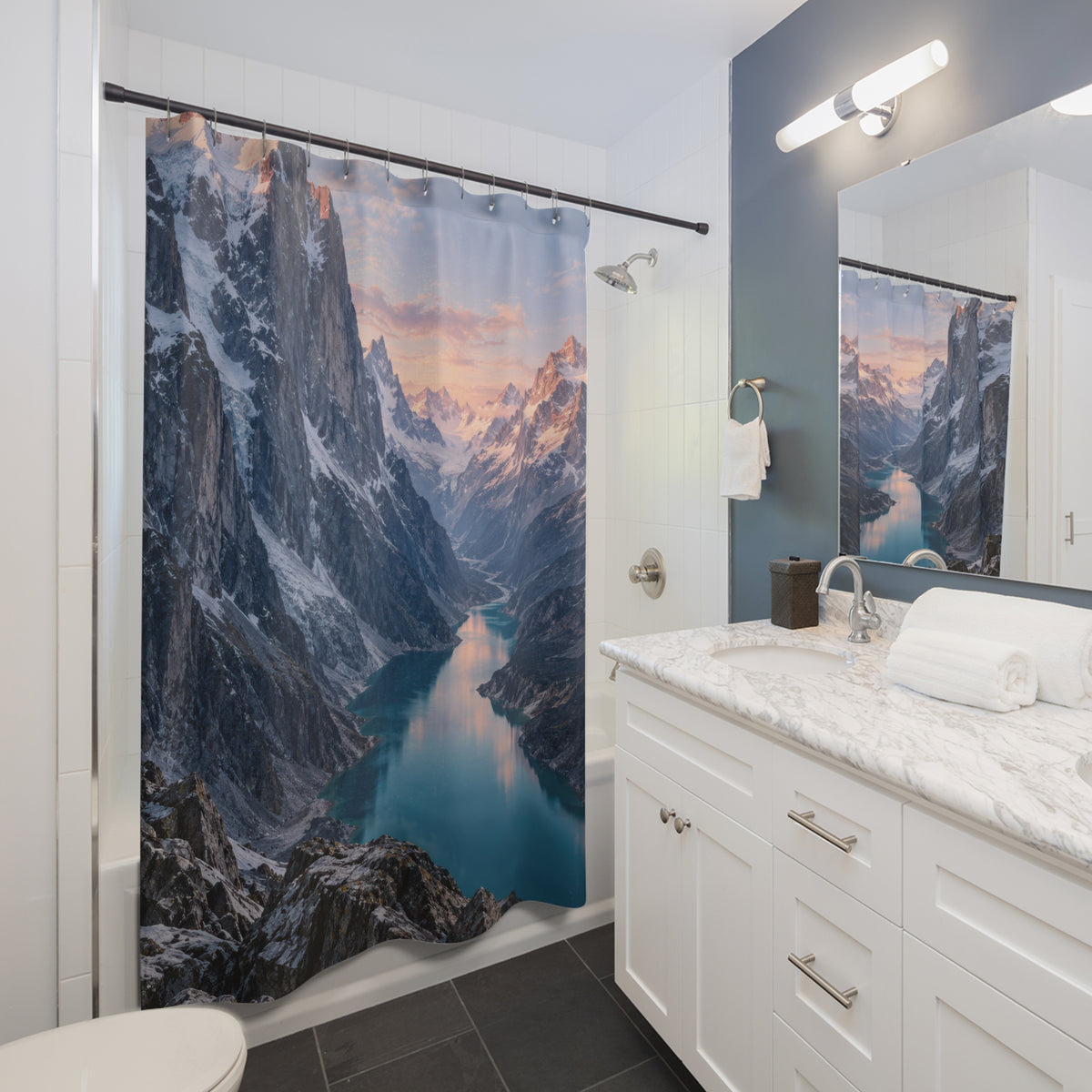 Rose-lit snowy mountains above a turquoise glacial lake shower curtain beside a white vanity