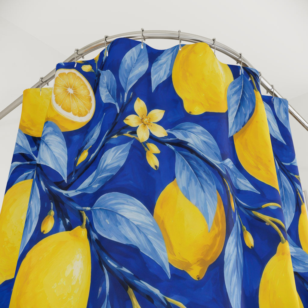 Yellow lemons and blossoms among blue leaves on cobalt shower curtain with close-up print, hooks, and folds