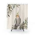 Grey cockatiel framed by airy olive branches on warm ivory shower curtain, full front view