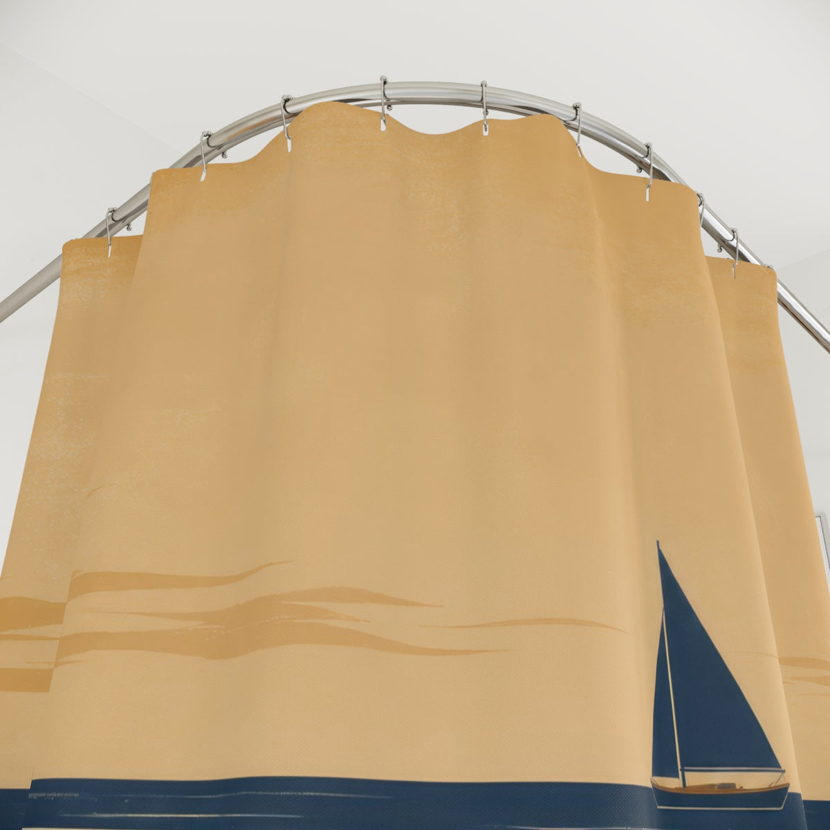 Navy sailboat crossing a broad tan sandbar under a warm sky shower curtain with close-up print, hooks, and folds