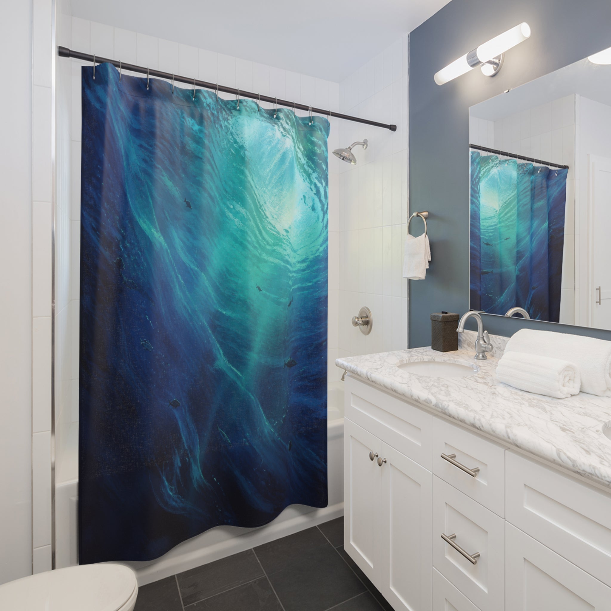 Deep indigo underwater currents with turquoise sunlight shower curtain beside a white vanity