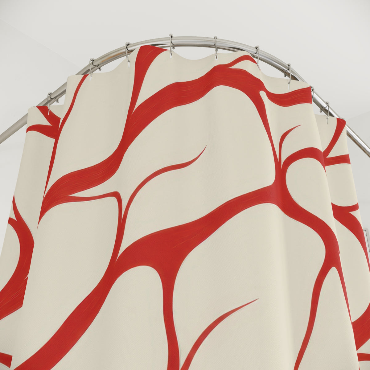 Red tapered branching lines across warm cream shower curtain with close-up print, hooks, and folds