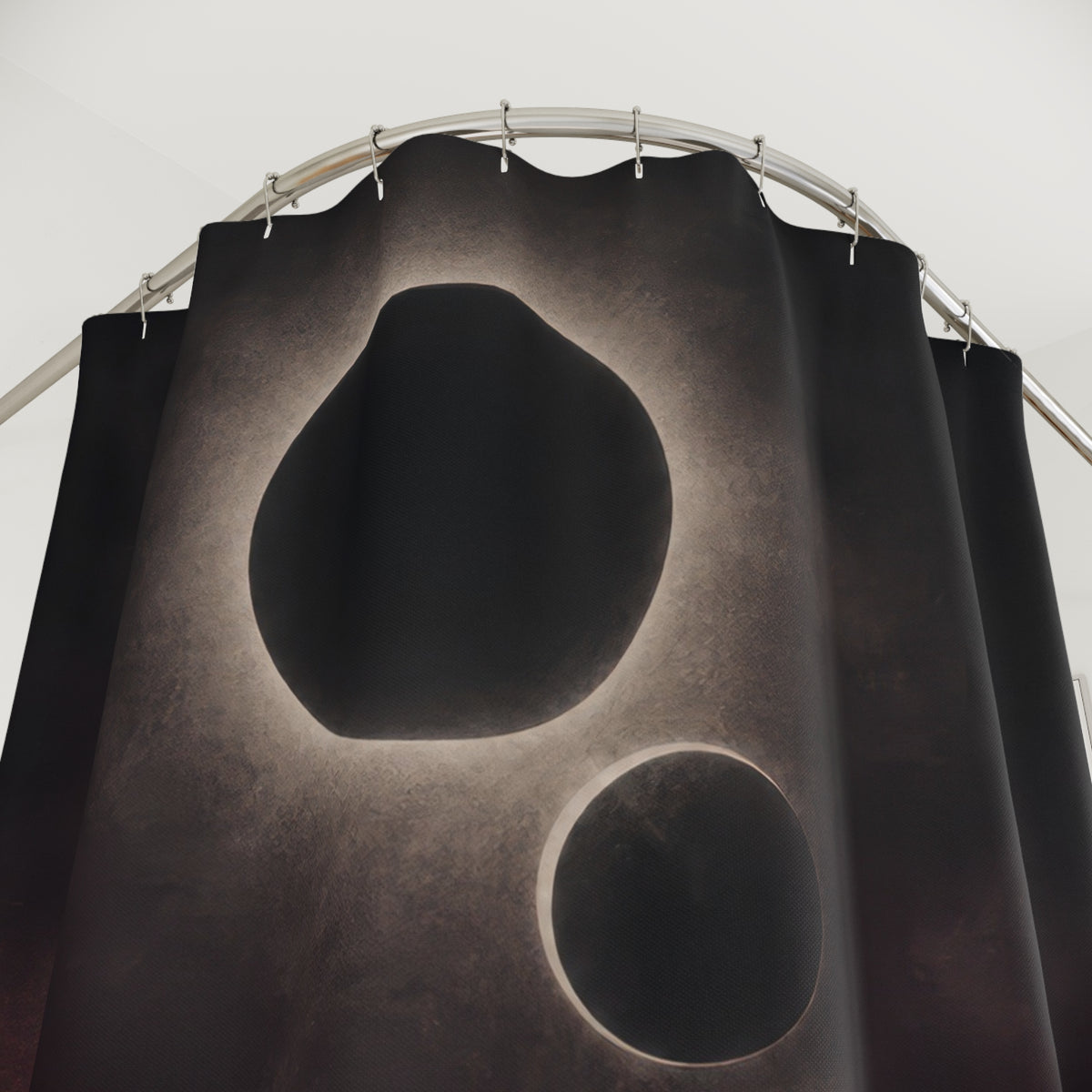 Charcoal eclipse with a silver halo and descending orbital forms shower curtain with close-up print, hooks, and folds