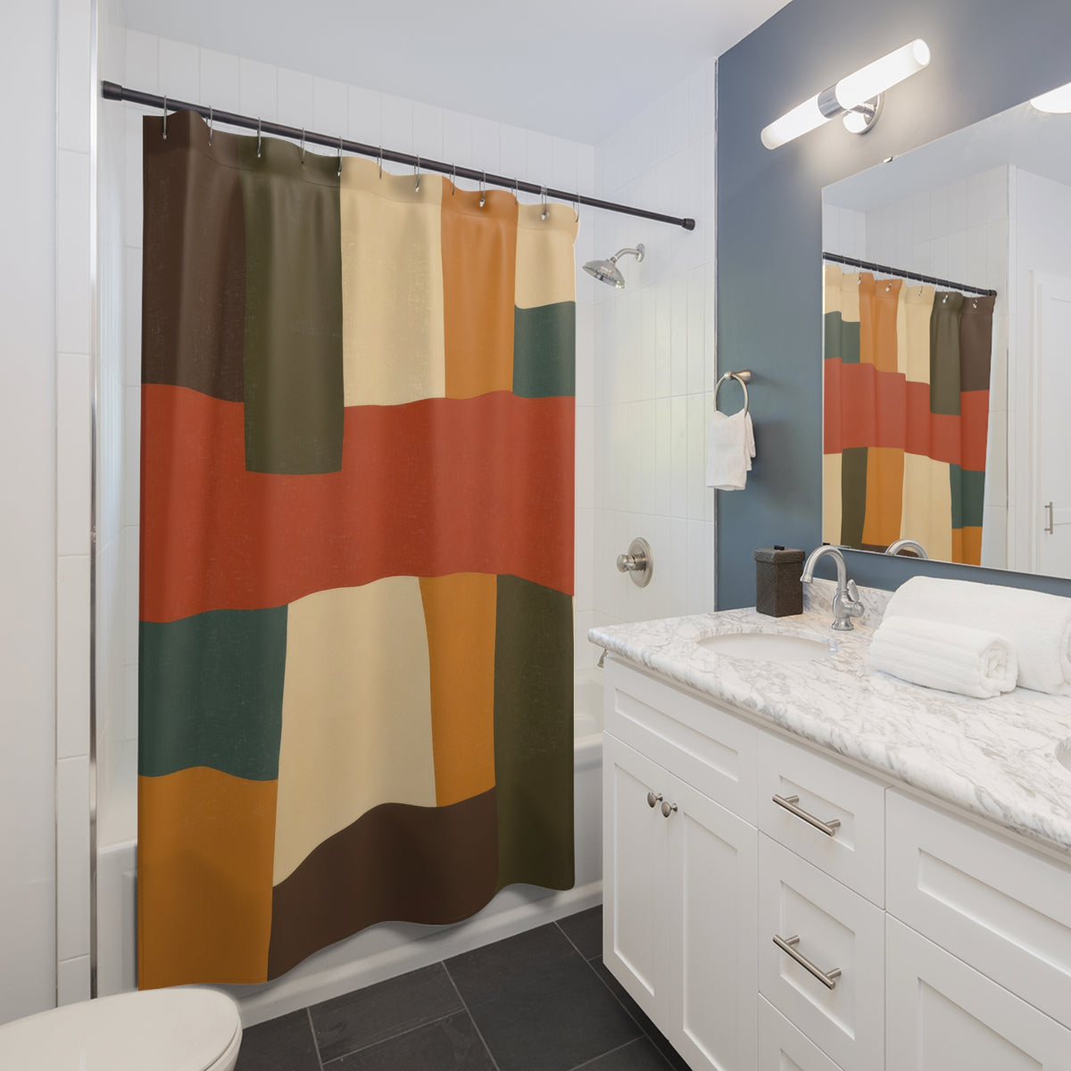 Earth tone interlocking color bands shower curtain beside a white vanity