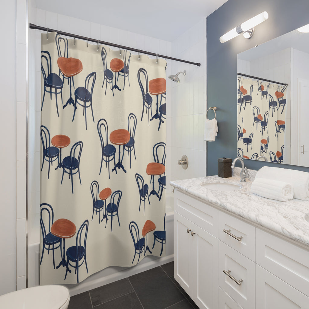 Navy bentwood chairs and terracotta café tables on ivory shower curtain beside a white vanity