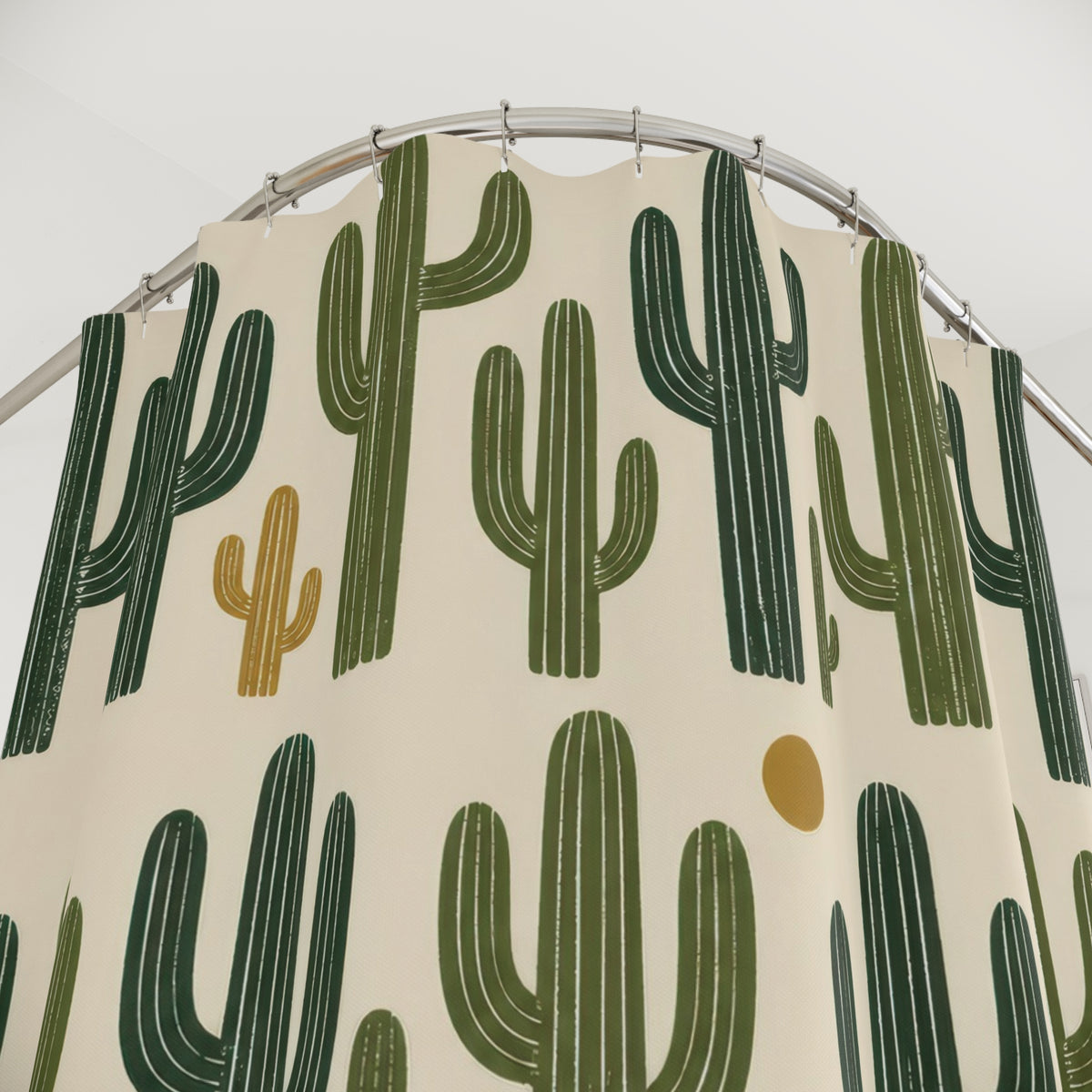 Green saguaro cactus pattern on cream shower curtain with close-up print, hooks, and folds