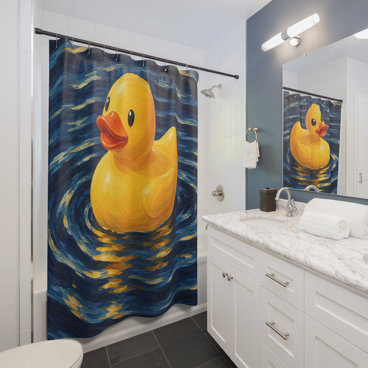 Yellow rubber duck on swirling navy water shower curtain beside a white vanity