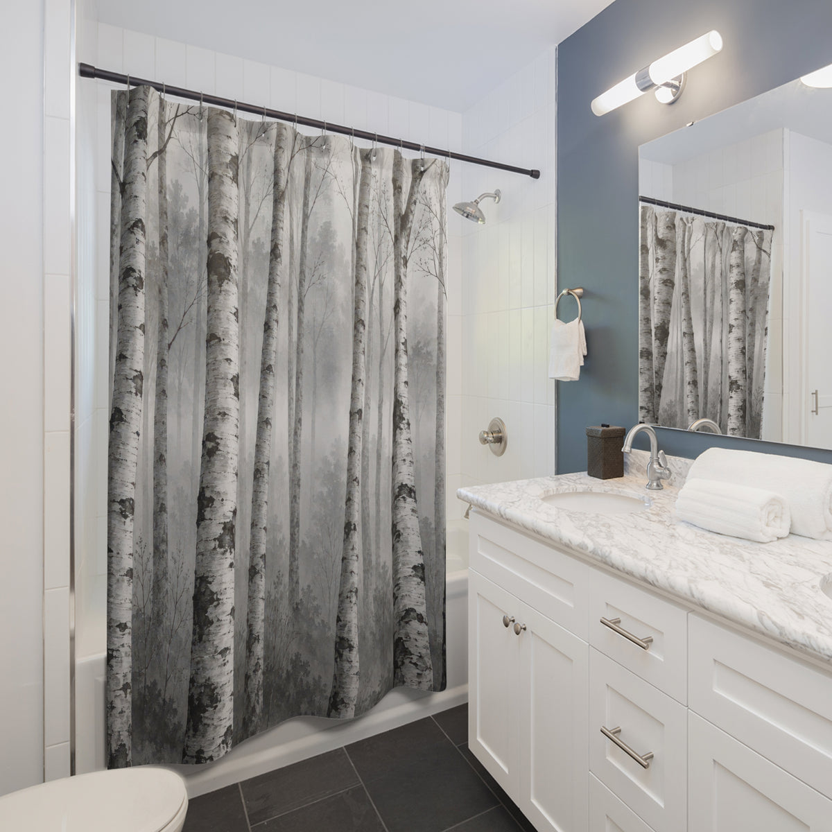 White birch tree trunks in grey mist shower curtain beside a white vanity
