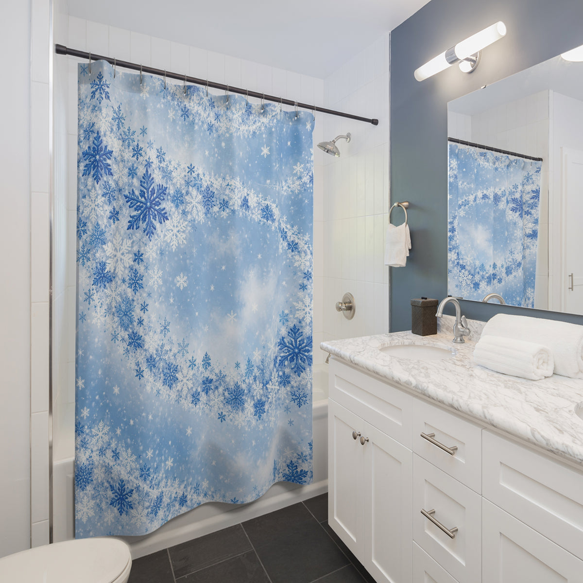 Blue orbital snowfall shower curtain beside a white vanity