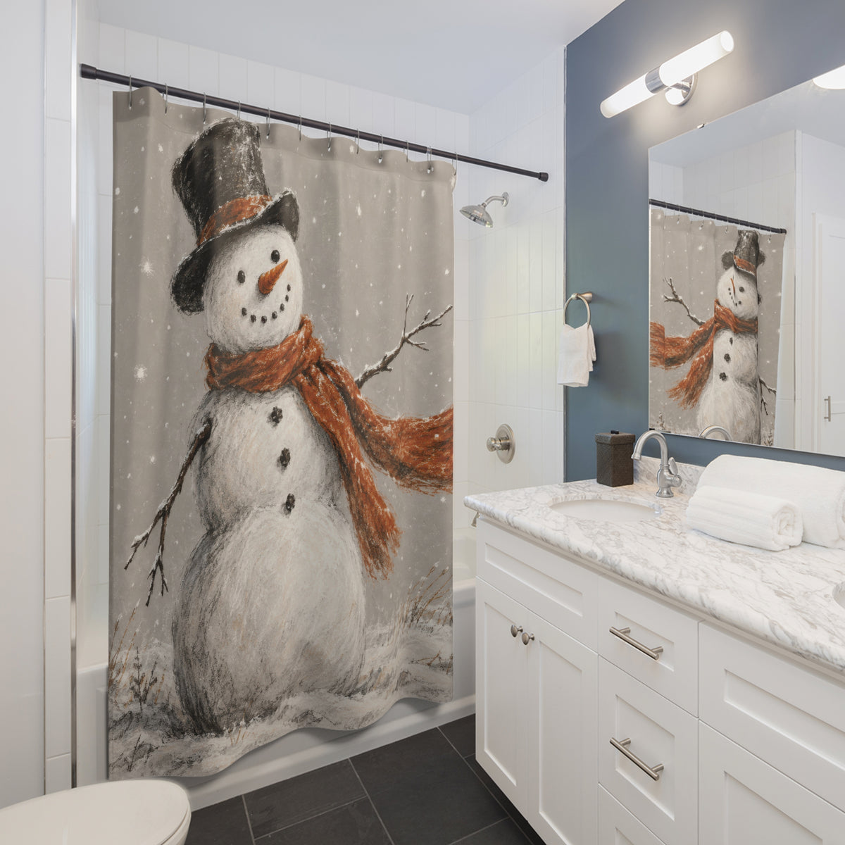 White snowman with orange scarf and black hat in grey snow shower curtain beside a white vanity