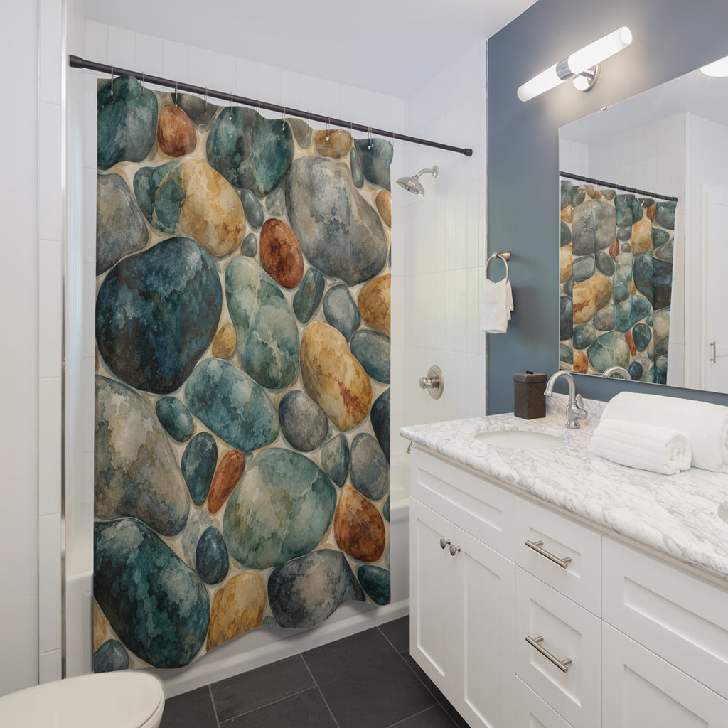 Teal, gray and ochre watercolor river stones shower curtain beside a white vanity