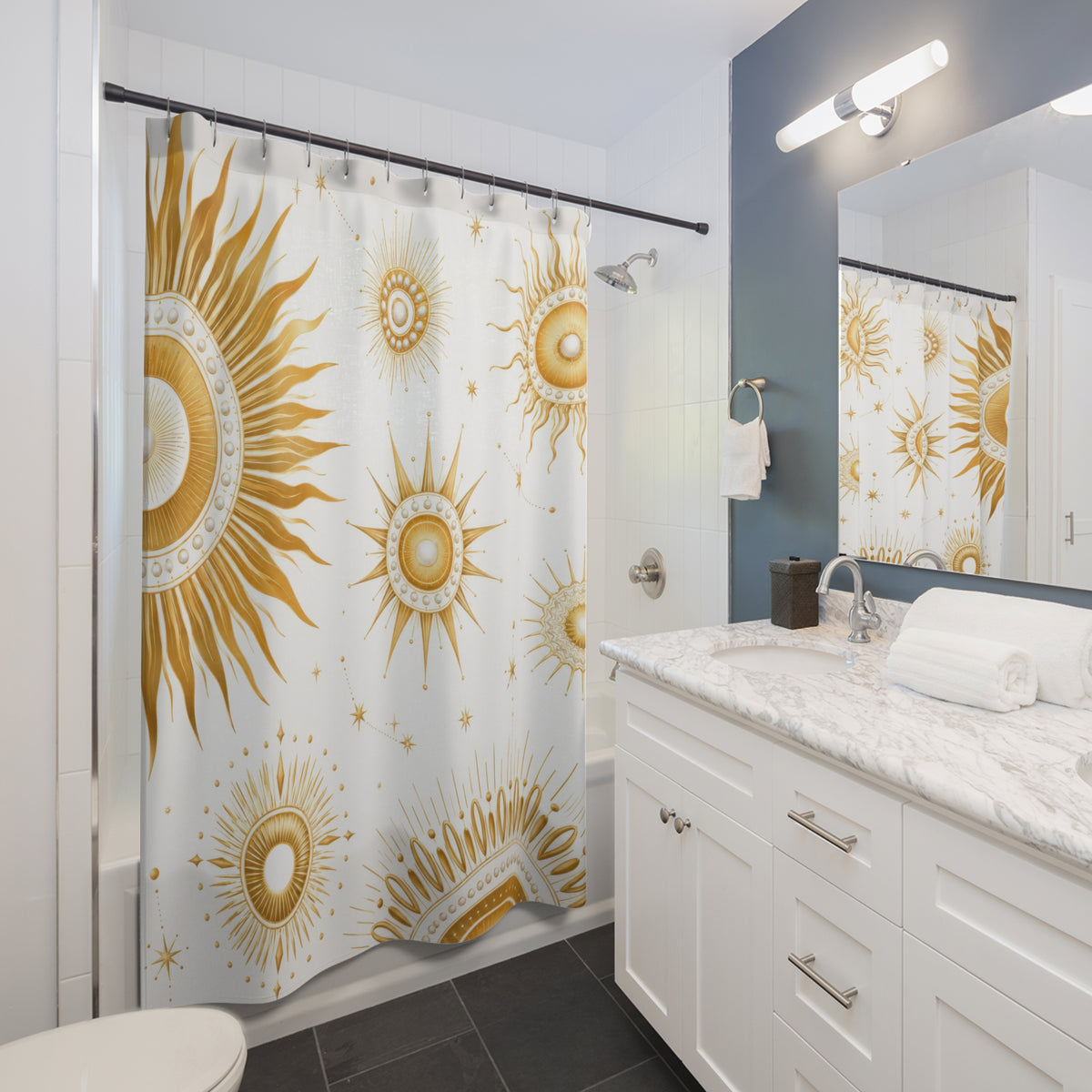 Gold sun medallions and starbursts on white shower curtain beside a white vanity