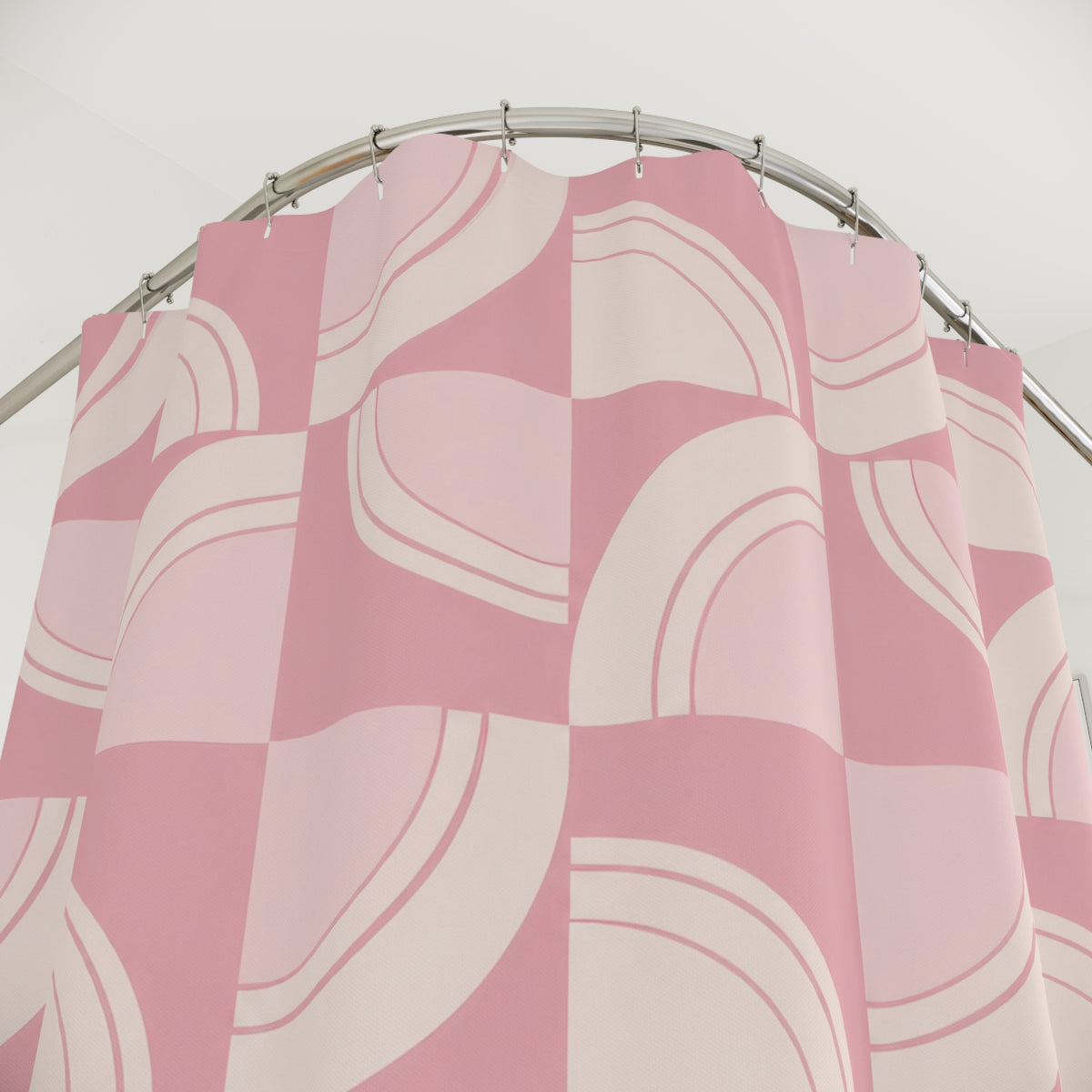 Light pink and cream retro arc tiles shower curtain with close-up print, hooks, and folds