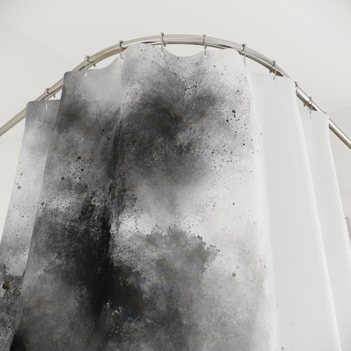 Black and gray granular ink washes beside open white space shower curtain with close-up print, hooks, and folds
